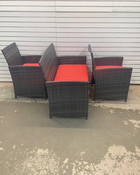 Costway 4 -Piece Rattan Patio Conversation Set with Red Cushions.