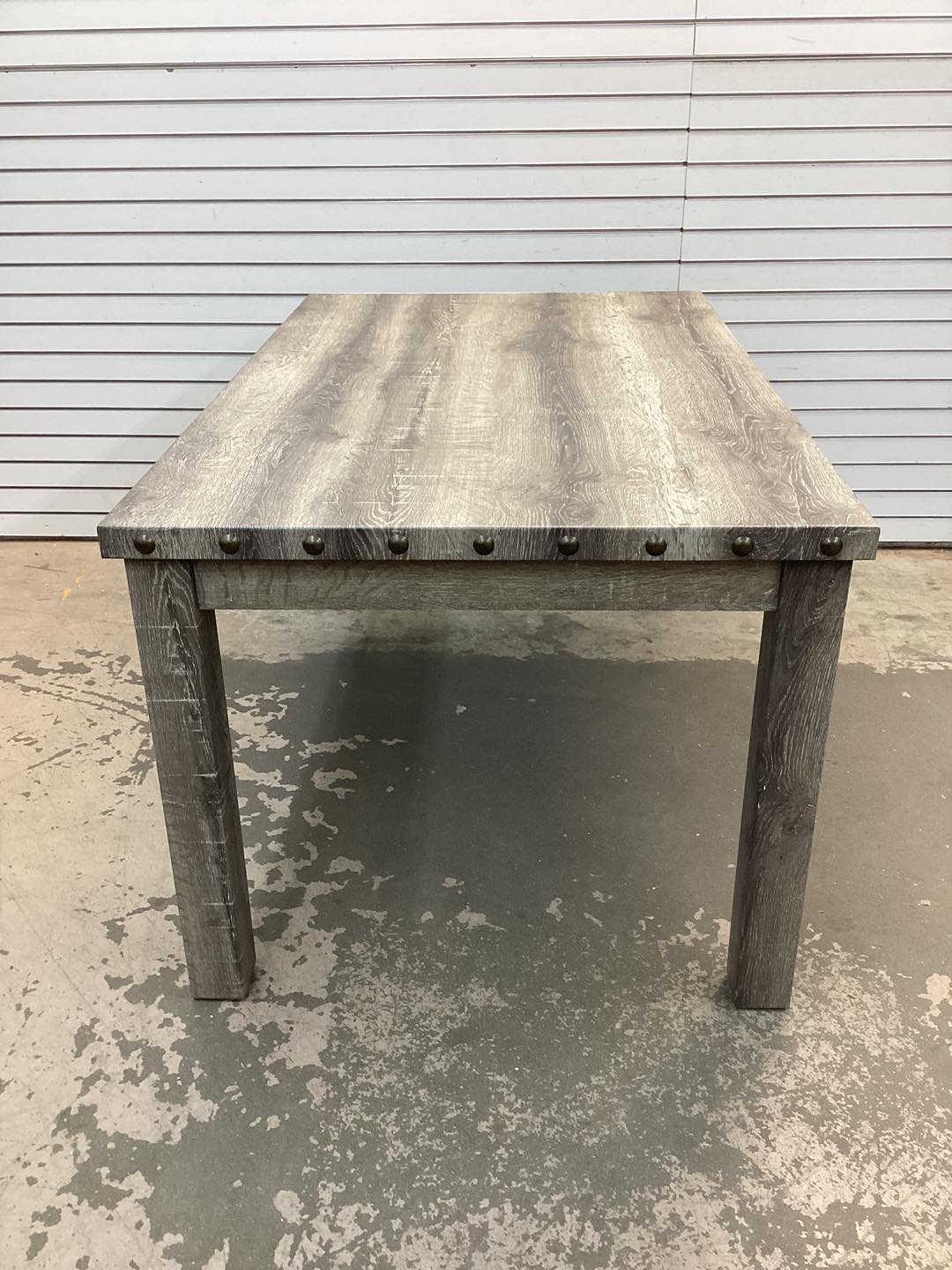 Fort Rustic Wood Dining Table with Rivets and Distressed Texture