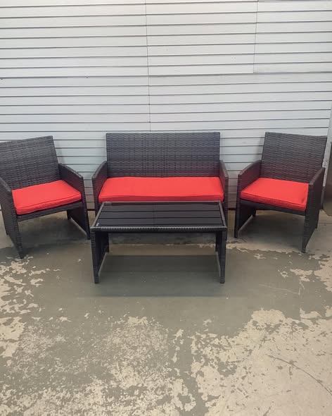 Costway 4 -Piece Rattan Patio Conversation Set with Red Cushions.